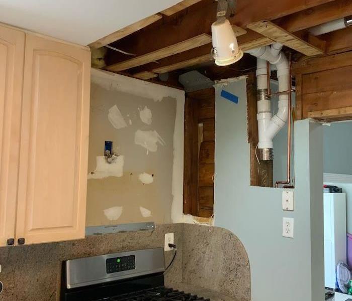 Kitchen with exposed ceiling framework