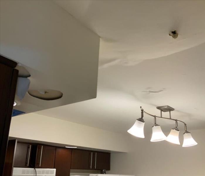Kitchen ceiling with water spots around a light fixture