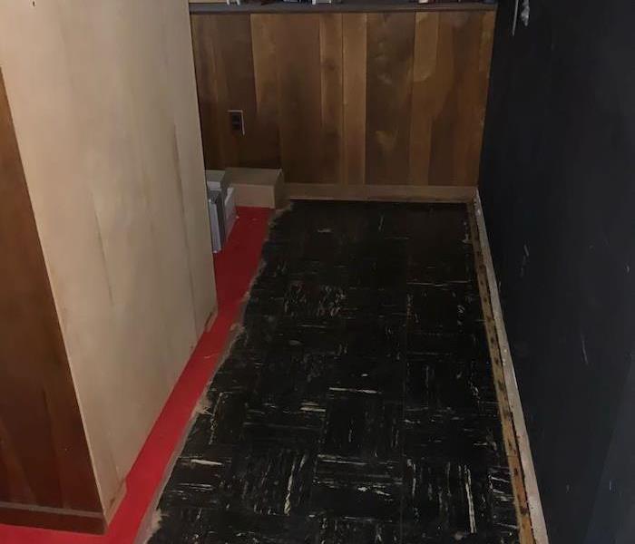 Room with black tile floor and red carpet