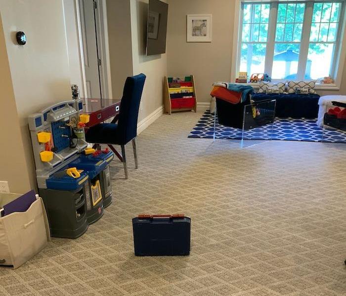 Room with beige carpet and children’s toys and furniture
