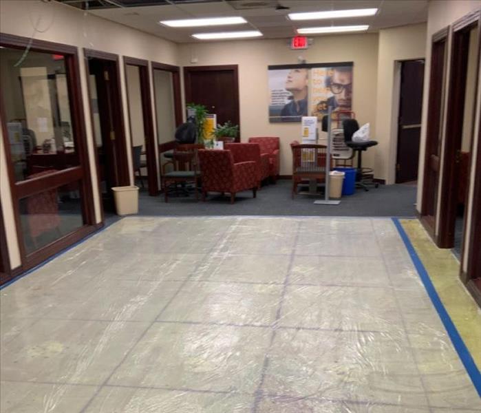  SERVPRO drying equipment in office hallway on tile flooring