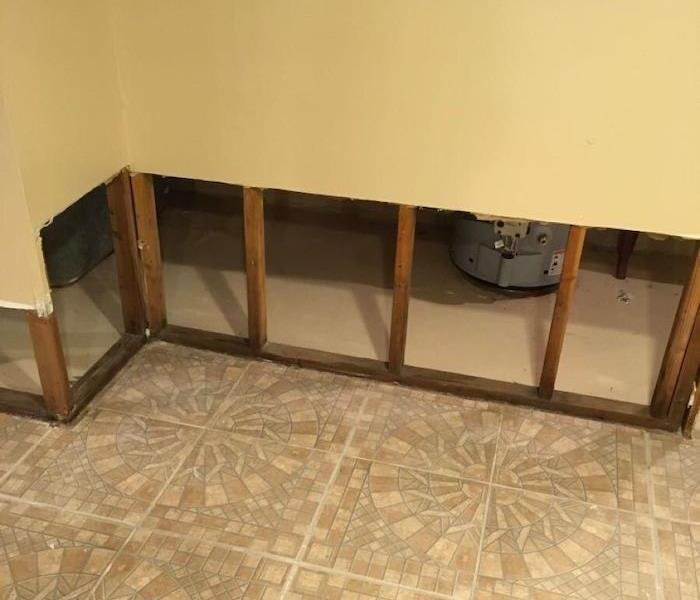 Room with tile floor and lower portion of wall removed 