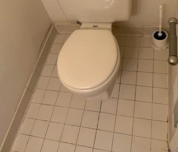 White toilet on tile floor 