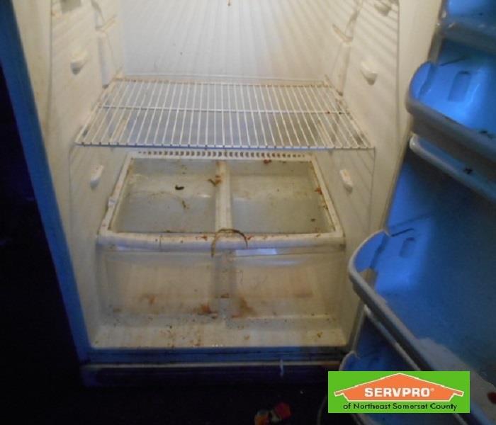 A empty dirty refrigerator. 