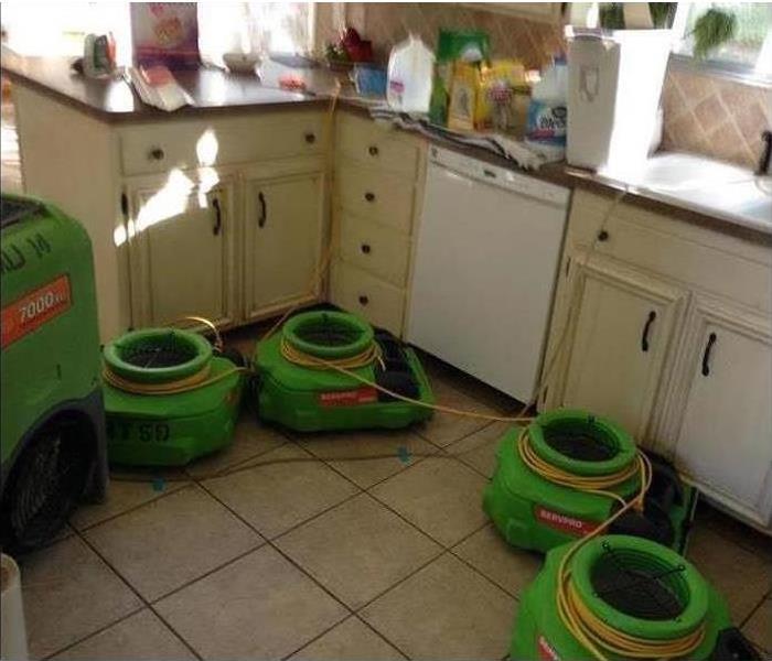 A kitchen with SERVPRO equipment on the floor. 