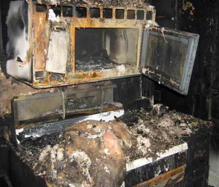 A kitchen with extensive fire damage. 