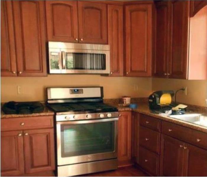 A kitchen with brown wood cabinets. 