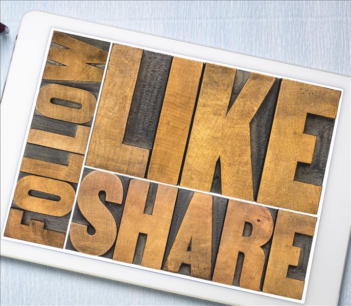 The words " FOLLOW LIKE SHARE" in wood carvings. 