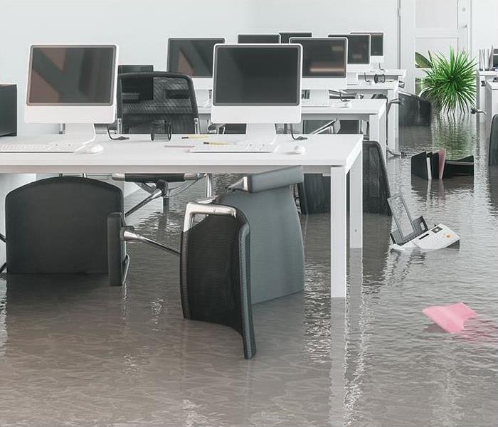 A office with chairs and desks with standing water. 